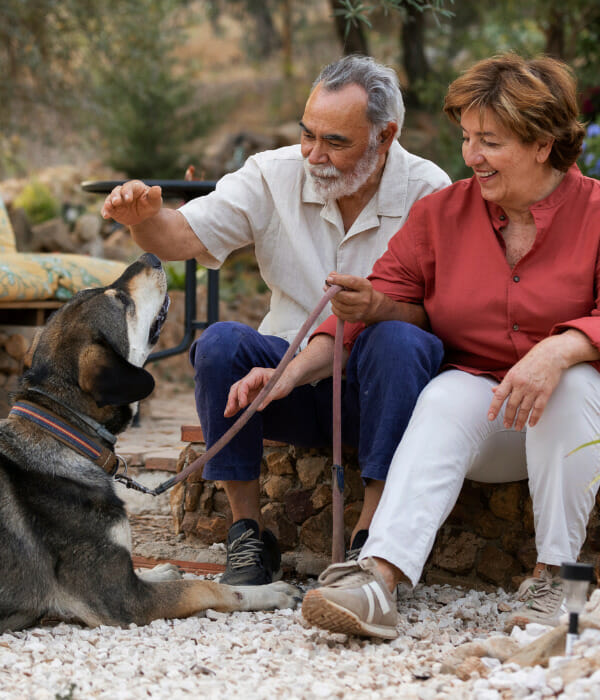 middle age couple playing with dog ec holdings